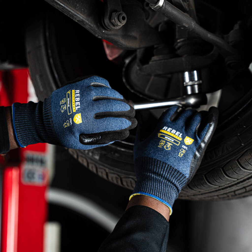 rebel versa wrist length gloves styled closeup working on car