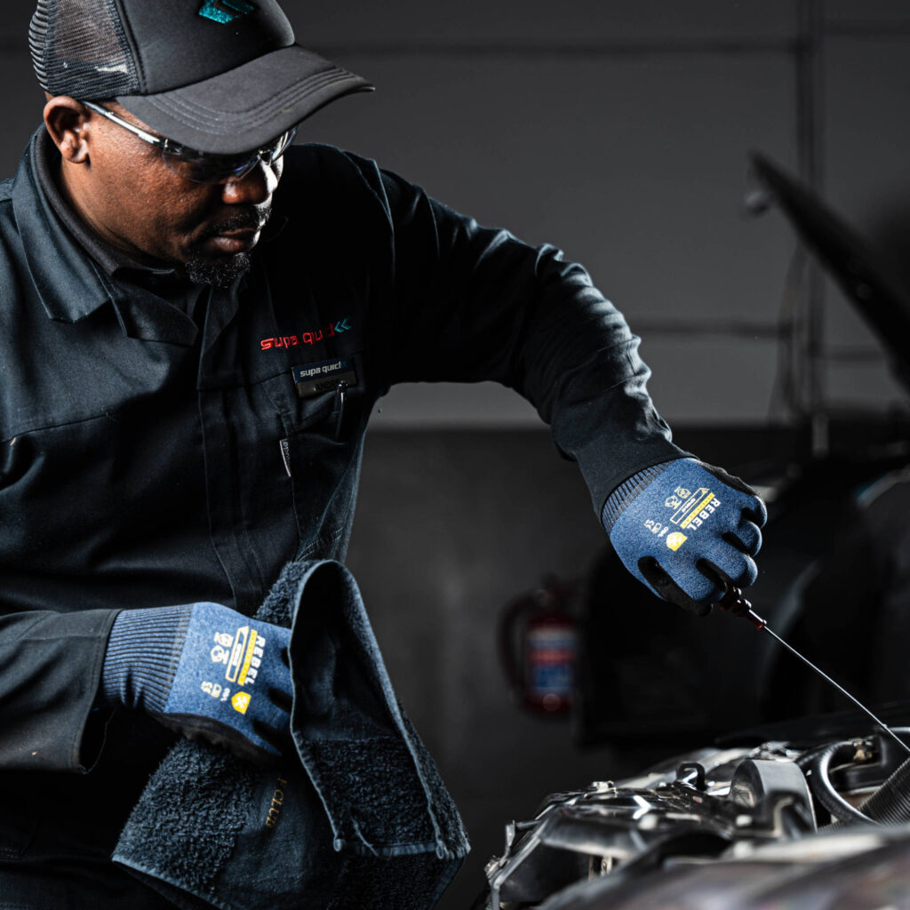 rebel versa wrist length gloves styled oil dipstick in hand