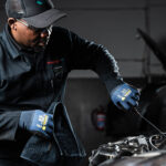 rebel versa wrist length gloves styled oil dipstick in hand